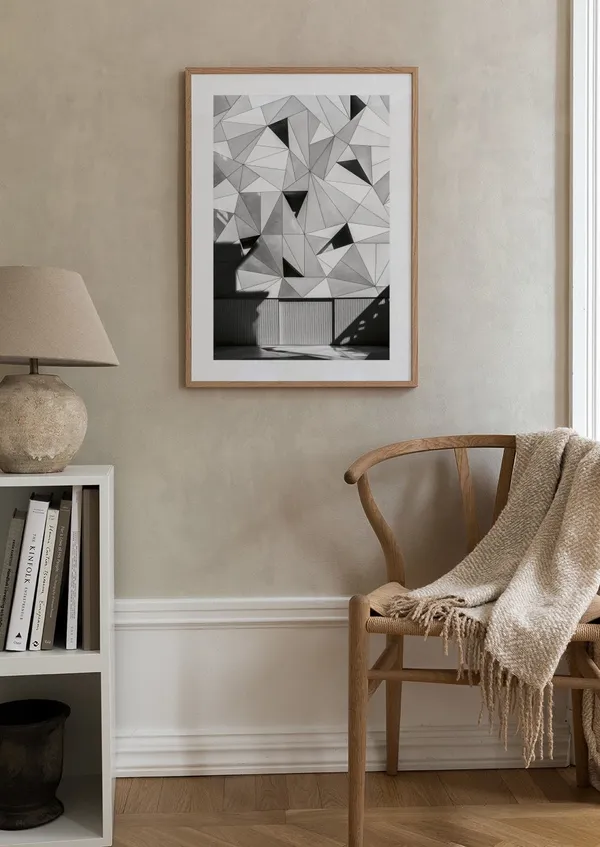Cozy reading corner with wooden chair and framed geometric print