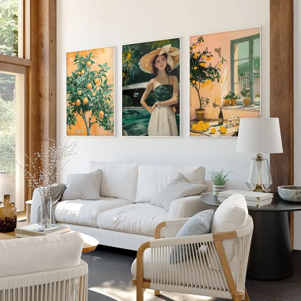 Bright living room with white sofa and three framed orange-themed artworks